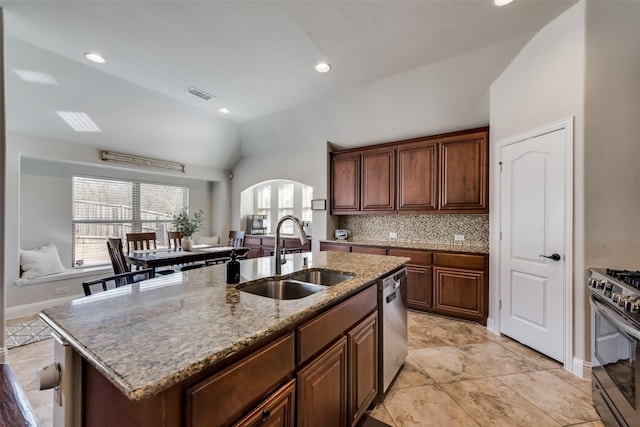 1003 Stanbridge Dr, Wylie, TX 75098 - kitchen with a sink, stainless steel appliances, lofted ceiling, arched walkways, and light stone counters