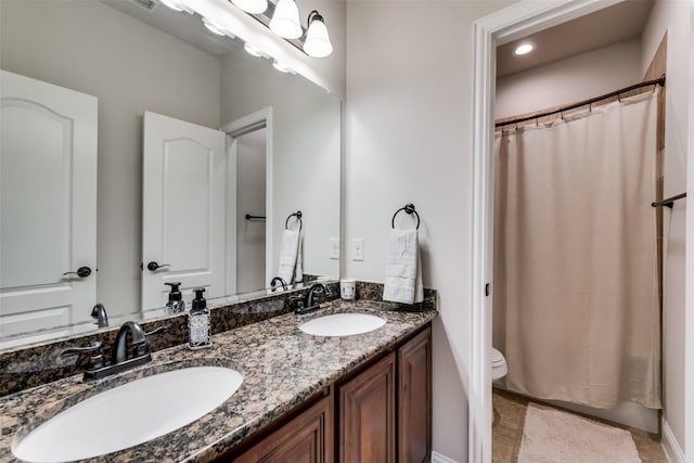 1003 Stanbridge Dr, Wylie, TX 75098 - full bath with toilet, double vanity, a shower with shower curtain, and tile patterned floors