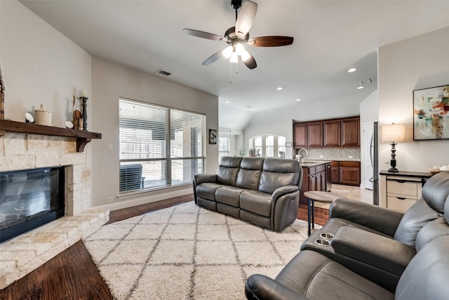 1003 Stanbridge Dr, Wylie, TX 75098 - living area featuring light wood-style flooring, ceiling fan, a stone fireplace, and recessed lighting