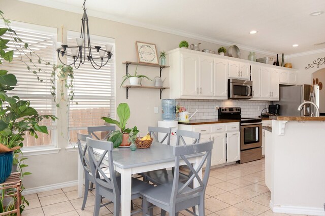 14221 Tijuana Trl, Fort Worth, TX 76052 - kitchen featuring stainless steel appliances, a chandelier, backsplash, white cabinetry, and ornamental molding