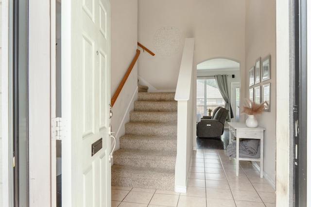 14221 Tijuana Trl, Fort Worth, TX 76052 - stairs with arched walkways, tile patterned floors, and baseboards