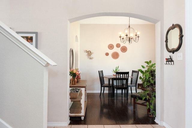 14221 Tijuana Trl, Fort Worth, TX 76052 - dining space with arched walkways, wood finished floors, baseboards, and a chandelier