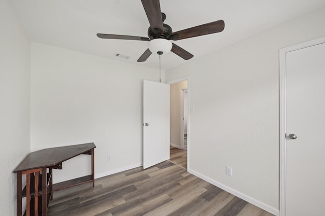 405 Rosemary Ln, Euless, TX 76039 - unfurnished bedroom with wood finished floors, baseboards, and ceiling fan