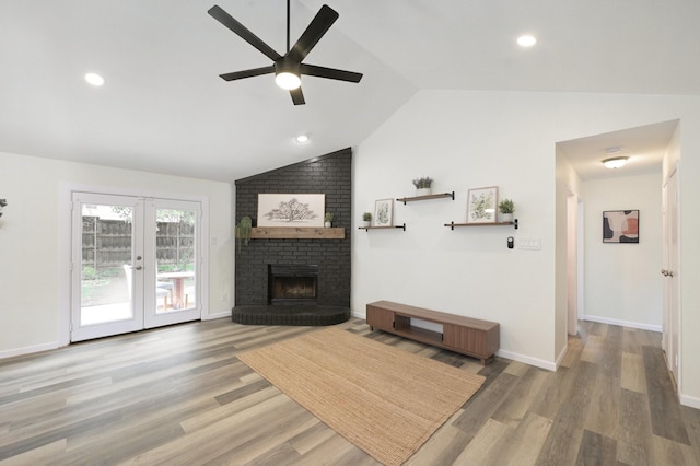 405 Rosemary Ln, Euless, TX 76039 - living room with vaulted ceiling, a ceiling fan, light wood finished floors, french doors, and a fireplace