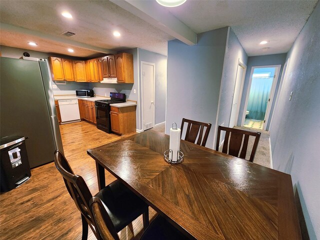 2908 Wilkinson Ave, Fort Worth, TX 76103 - dining space with light wood-type flooring, recessed lighting, and a textured ceiling