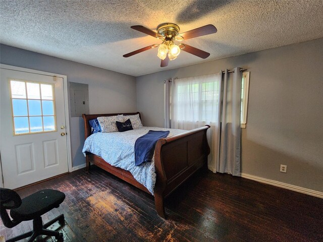 2908 Wilkinson Ave, Fort Worth, TX 76103 - bedroom with electric panel, baseboards, dark wood-style floors, a ceiling fan, and a textured ceiling