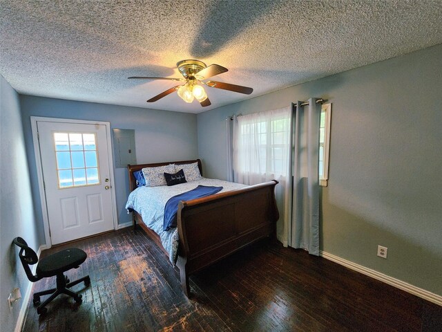 2908 Wilkinson Ave, Fort Worth, TX 76103 - bedroom with multiple windows, baseboards, hardwood / wood-style flooring, electric panel, and a textured ceiling