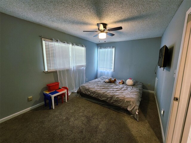 2908 Wilkinson Ave, Fort Worth, TX 76103 - carpeted bedroom featuring a textured ceiling, baseboards, and a ceiling fan