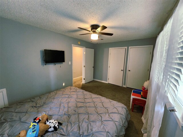 2908 Wilkinson Ave, Fort Worth, TX 76103 - carpeted bedroom featuring two closets, a textured ceiling, and a ceiling fan