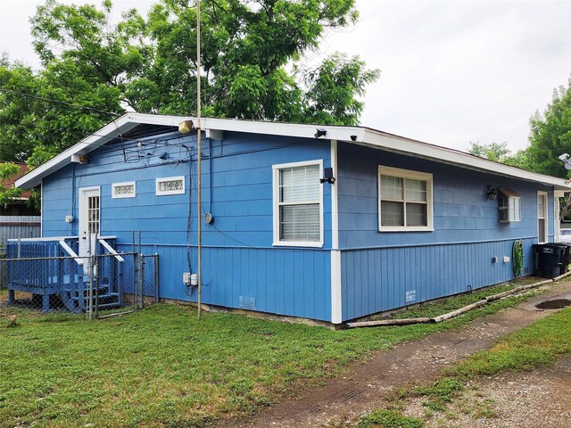 2908 Wilkinson Ave, Fort Worth, TX 76103 - view of side of property featuring a wooden deck, a lawn, and cooling unit