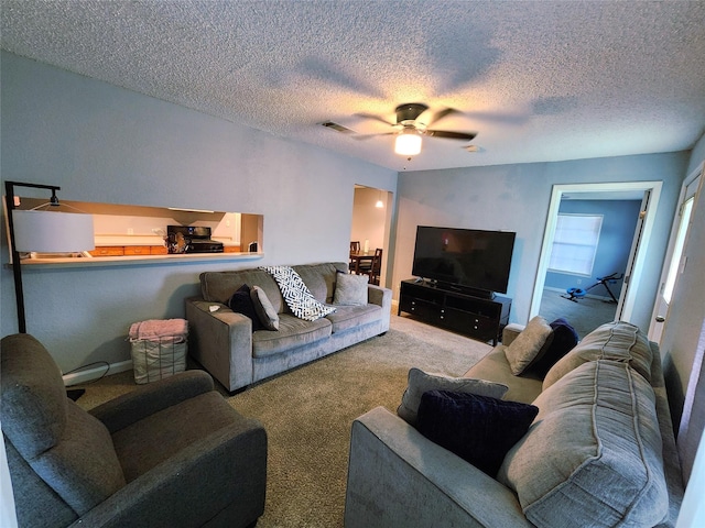 2908 Wilkinson Ave, Fort Worth, TX 76103 - carpeted living room with a ceiling fan and a textured ceiling