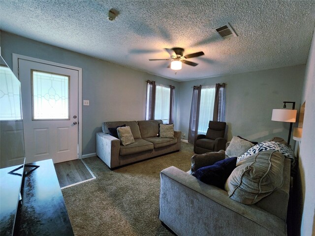 2908 Wilkinson Ave, Fort Worth, TX 76103 - living area featuring a ceiling fan, carpet floors, a textured ceiling, and baseboards