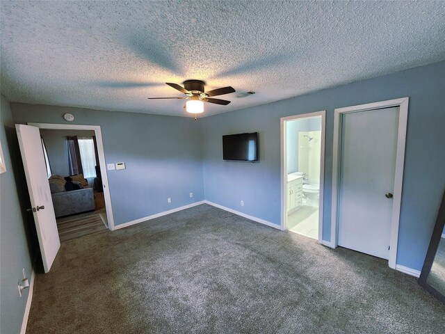 2908 Wilkinson Ave, Fort Worth, TX 76103 - unfurnished bedroom featuring carpet, baseboards, a textured ceiling, and ensuite bath