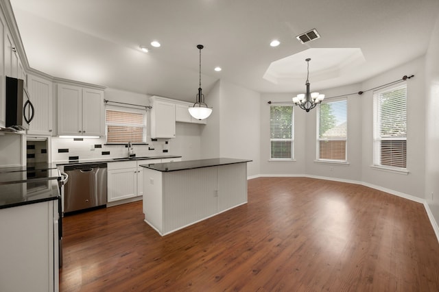 6345 Pinionpark Way, Fort Worth, TX 76179 - kitchen featuring stainless steel appliances, a sink, dark countertops, a tray ceiling, and dark wood-style flooring