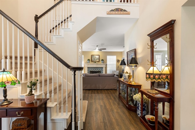 3625 Mackenzie Ln, Richardson, TX 75082 - foyer featuring dark wood finished floors, ceiling fan, stairway, a towering ceiling, and a tile fireplace