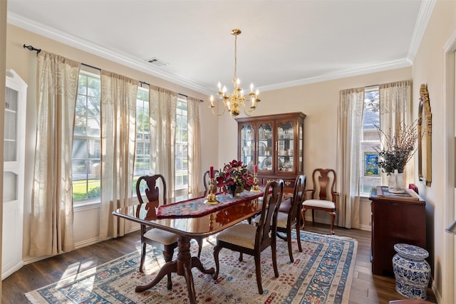 3625 Mackenzie Ln, Richardson, TX 75082 - dining space featuring healthy amount of natural light, a chandelier, crown molding, and dark wood-type flooring
