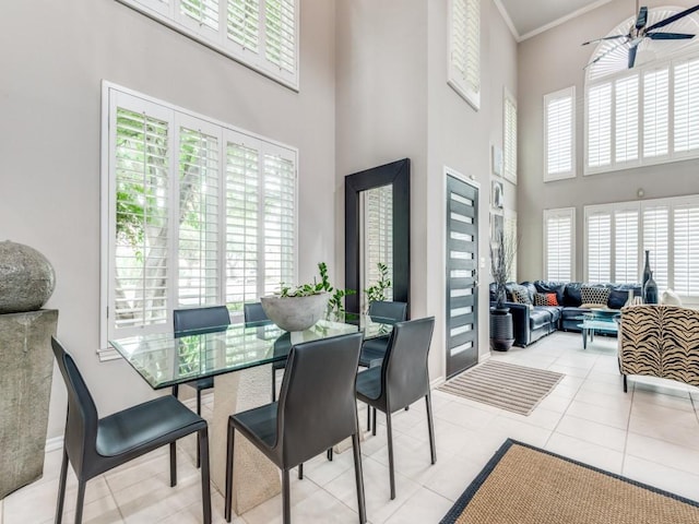 18004 Windflower Way, Dallas, TX 75252 - tiled dining area featuring a high ceiling, ceiling fan, baseboards, and ornamental molding