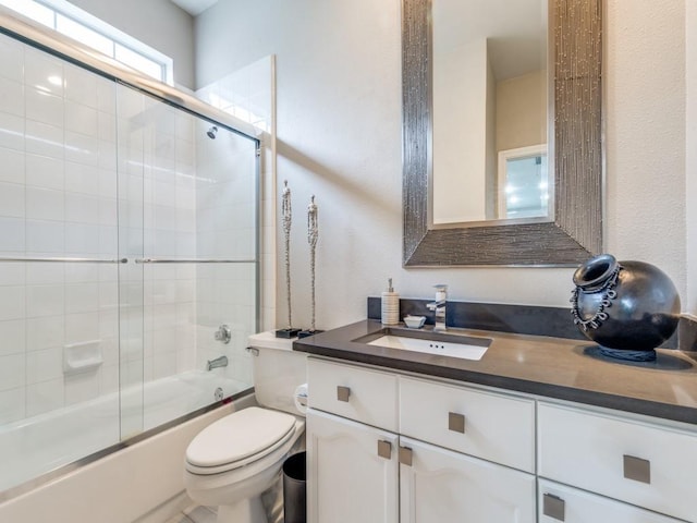 18004 Windflower Way, Dallas, TX 75252 - bathroom featuring toilet, enclosed tub / shower combo, and vanity