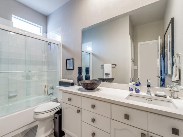 18004 Windflower Way, Dallas, TX 75252 - full bathroom featuring toilet, vanity, and bath / shower combo with glass door