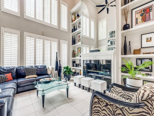 18004 Windflower Way, Dallas, TX 75252 - living area with a towering ceiling, tile patterned floors, a ceiling fan, and built in shelves