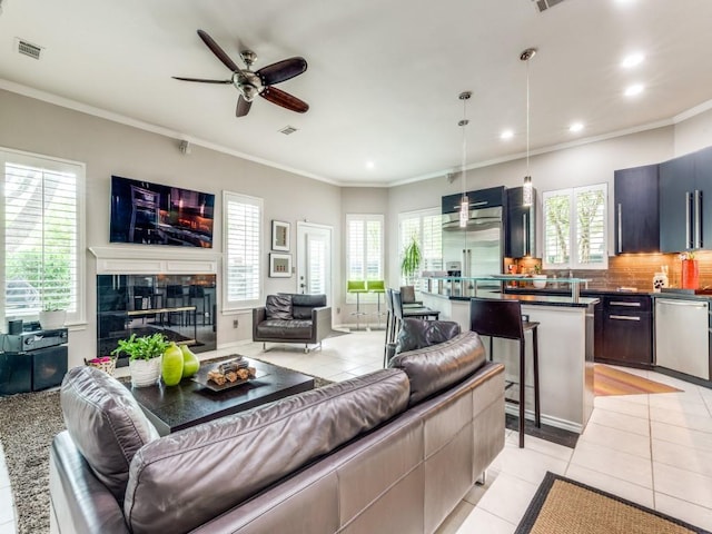18004 Windflower Way, Dallas, TX 75252 - living room featuring recessed lighting, ceiling fan, light tile patterned floors, healthy amount of natural light, and ornamental molding