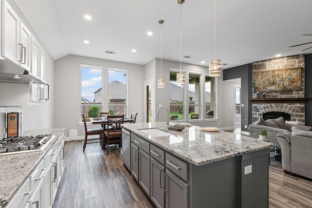 1725 Lithgow Rd, Celina, TX 75009 - kitchen featuring a sink, gray cabinetry, a stone fireplace, appliances with stainless steel finishes, and dark wood finished floors