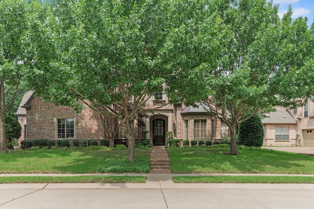 7300 Thames Trl, Colleyville, TX 76034 - view of front of home with brick siding, a front lawn, and a garage
