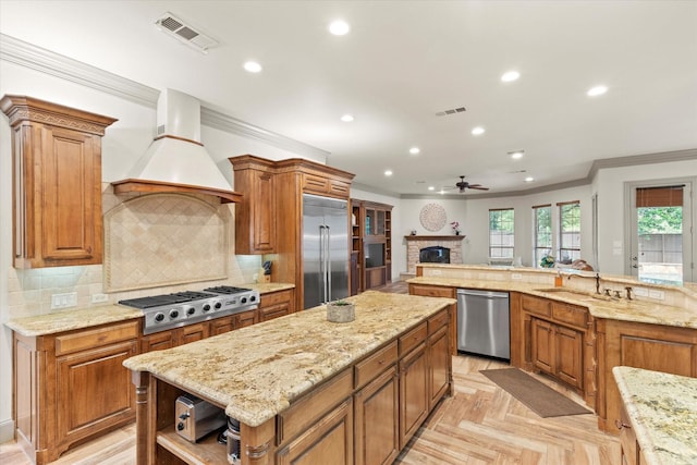 7300 Thames Trl, Colleyville, TX 76034 - kitchen featuring stainless steel appliances, a kitchen island, a sink, crown molding, and a brick fireplace