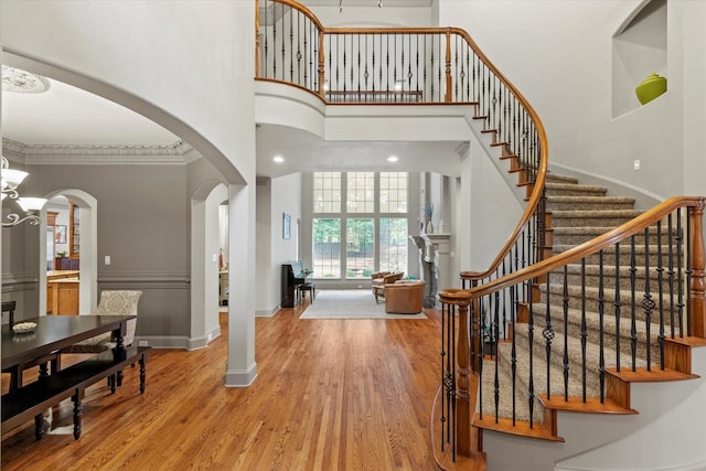 7300 Thames Trl, Colleyville, TX 76034 - entryway featuring a towering ceiling, arched walkways, wood finished floors, stairs, and baseboards