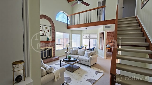 18040 Midway Rd Unit 123, Dallas, TX 75287 - carpeted living room with a ceiling fan, healthy amount of natural light, stairway, a towering ceiling, and baseboards