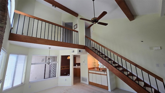18040 Midway Rd Unit 123, Dallas, TX 75287 - stairs with carpet, beamed ceiling, a chandelier, a ceiling fan, and a towering ceiling