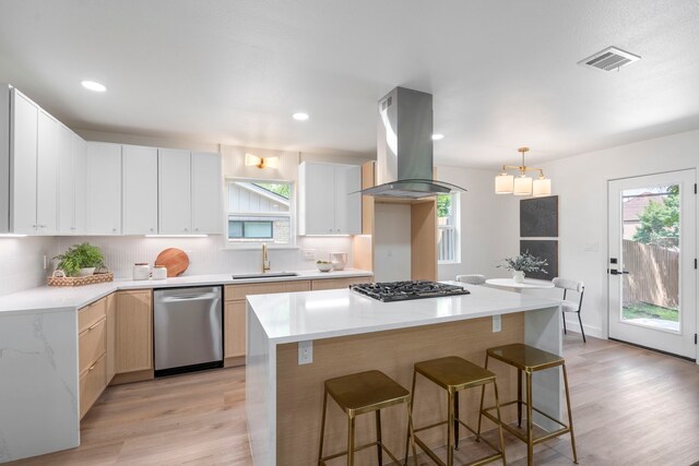 8317 Angier Way, Dallas, TX 75228 - kitchen featuring stainless steel dishwasher, island exhaust hood, a sink, gas stovetop, and light wood finished floors