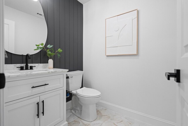 8317 Angier Way, Dallas, TX 75228 - bathroom featuring marble look tile flooring, toilet, vanity, and baseboards
