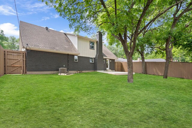 8317 Angier Way, Dallas, TX 75228 - rear view of house with a patio, roof with shingles, a chimney, central air condition unit, and brick siding