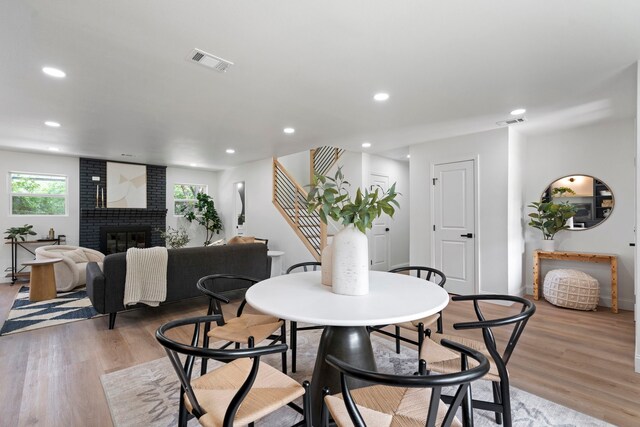 8317 Angier Way, Dallas, TX 75228 - dining area featuring stairway, light wood-style flooring, a fireplace, recessed lighting, and baseboards