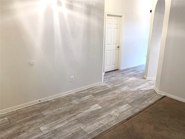 11711 Corsicana Dr, Frisco, TX 75035 - unfurnished room featuring arched walkways, wood finished floors, and baseboards