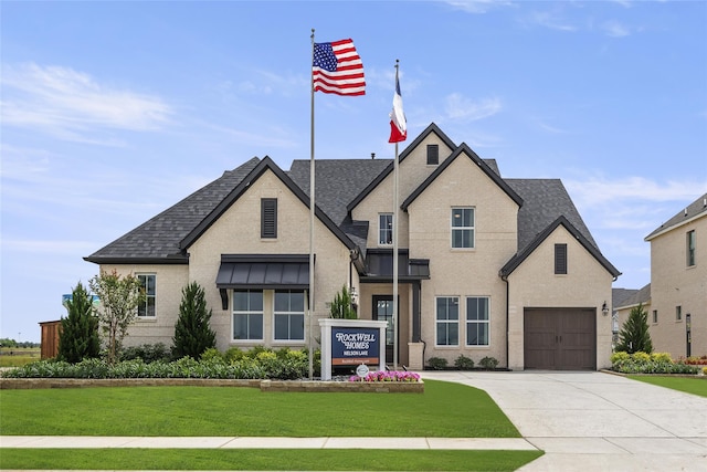 2016 Morris St, Rockwall, TX 75087 - view of front facade with roof with shingles, concrete driveway, and a front lawn