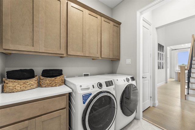 2016 Morris St, Rockwall, TX 75087 - laundry room with cabinet space, washer and clothes dryer, light wood finished floors, and baseboards