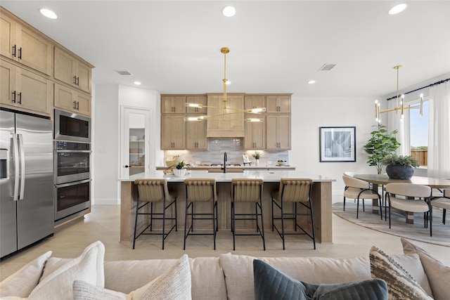 2016 Morris St, Rockwall, TX 75087 - kitchen featuring stainless steel appliances, open floor plan, light brown cabinets, decorative backsplash, and recessed lighting