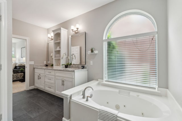 11487 Balcones Dr, Frisco, TX 75033 - ensuite bathroom with double vanity, a jetted tub, and tile patterned floors