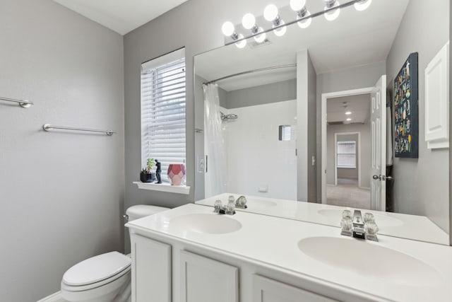 11487 Balcones Dr, Frisco, TX 75033 - bathroom with toilet, double vanity, healthy amount of natural light, and a shower with shower curtain