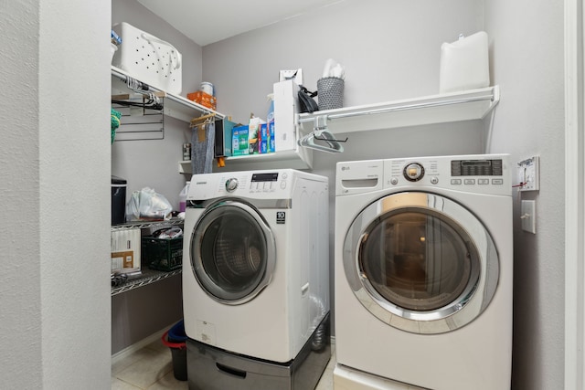 11487 Balcones Dr, Frisco, TX 75033 - washroom featuring separate washer and dryer and light tile patterned floors
