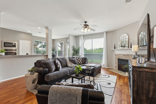 11487 Balcones Dr, Frisco, TX 75033 - living room with a fireplace with flush hearth, baseboards, ceiling fan, hardwood / wood-style flooring, and healthy amount of natural light