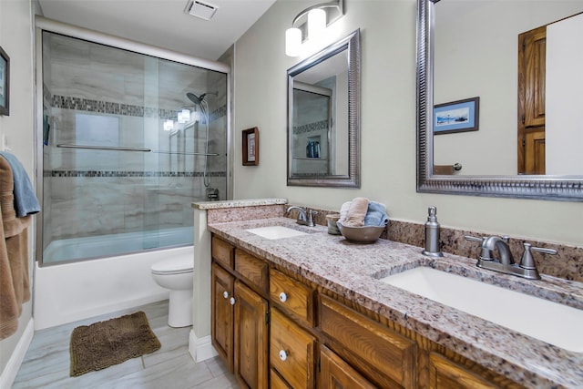 674 Milam Rd, Van Alstyne, TX 75495 - full bath with toilet, double vanity, and bath / shower combo with glass door