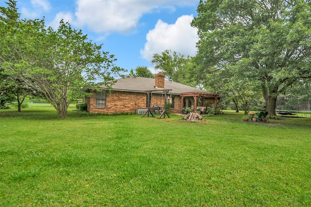 674 Milam Rd, Van Alstyne, TX 75495 - back of property with a pergola, a yard, a chimney, and brick siding