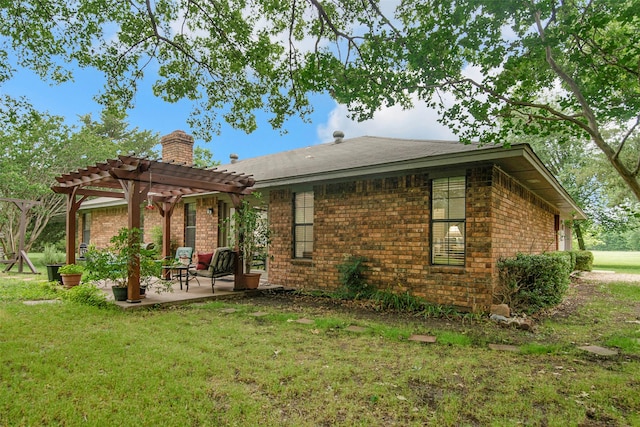 674 Milam Rd, Van Alstyne, TX 75495 - back of property with a pergola, a patio area, a chimney, a yard, and brick siding