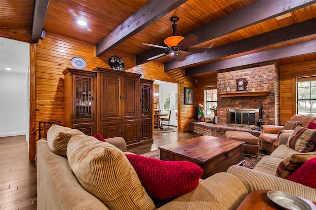 674 Milam Rd, Van Alstyne, TX 75495 - living area with wood walls, wood finished floors, ceiling fan, wood ceiling with exposed beams, and a fireplace