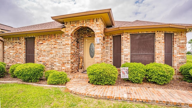 9100 Bellechase, Granbury, TX 76049 - view of exterior entry featuring brick siding and roof with shingles