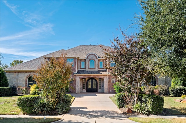 2112 Beaver Creek Ln, Southlake, TX 76092 - view of front facade featuring french doors, driveway, brick siding, and stone siding