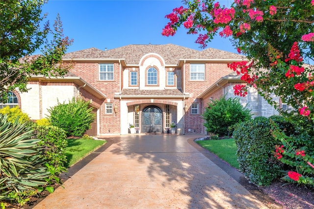 2112 Beaver Creek Ln, Southlake, TX 76092 - view of front facade with french doors, brick siding, and concrete driveway